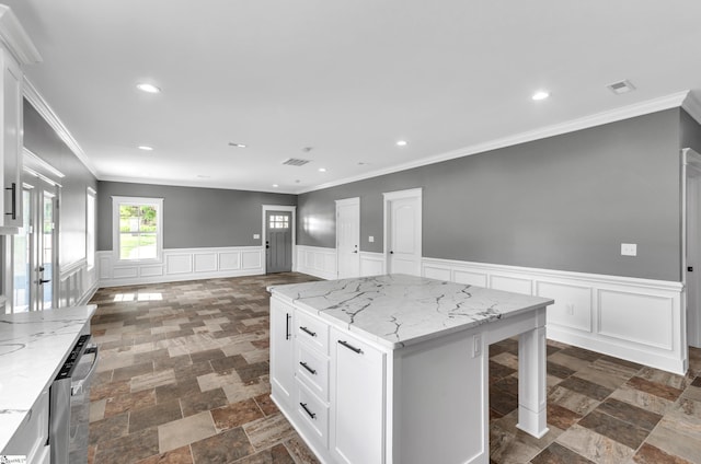 kitchen featuring open floor plan, a center island, white cabinetry, and recessed lighting