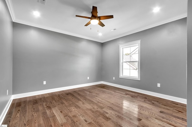 spare room with baseboards, ceiling fan, dark wood-type flooring, and crown molding