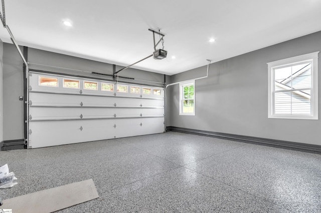 garage with recessed lighting, baseboards, and a garage door opener
