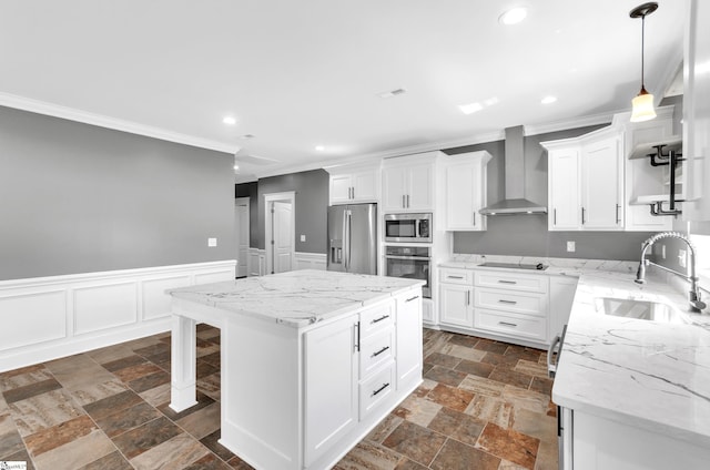 kitchen featuring a sink, wall chimney exhaust hood, stone tile flooring, and appliances with stainless steel finishes