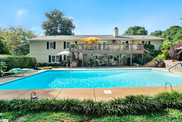 view of swimming pool featuring a deck