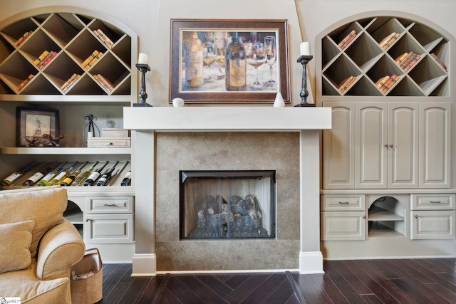 interior space with a tile fireplace and wood-type flooring