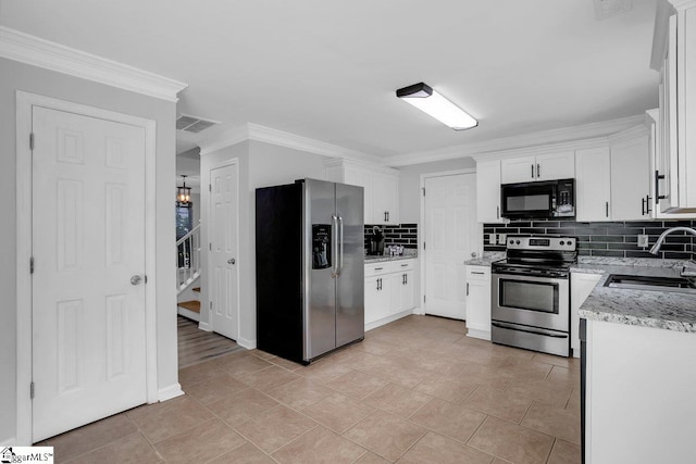 kitchen with appliances with stainless steel finishes, backsplash, light tile patterned floors, and sink