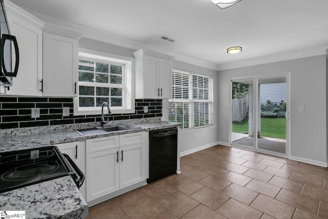 kitchen featuring black appliances, a wealth of natural light, sink, and backsplash