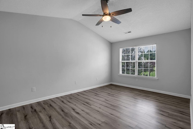 spare room featuring ceiling fan, hardwood / wood-style flooring, a textured ceiling, and vaulted ceiling