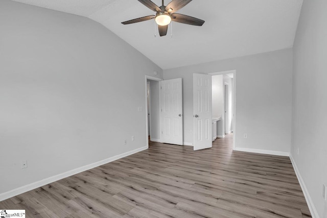 unfurnished bedroom with ceiling fan, wood-type flooring, and vaulted ceiling