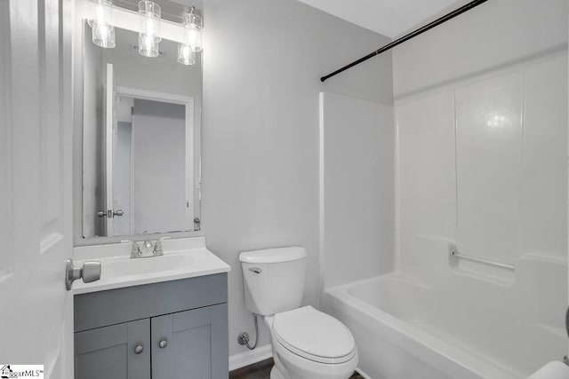 full bathroom with toilet, vanity, and shower / washtub combination