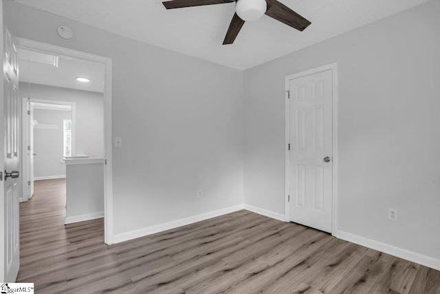 unfurnished room with ceiling fan and hardwood / wood-style flooring