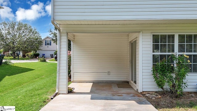 view of exterior entry featuring a lawn