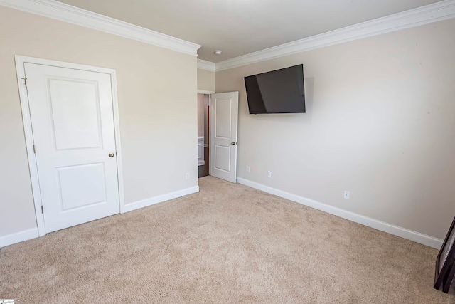 unfurnished bedroom with light carpet and crown molding