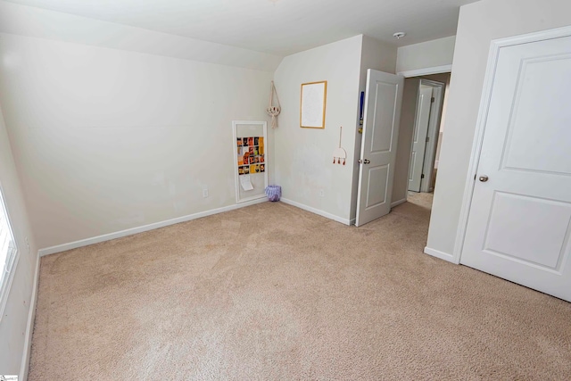 unfurnished bedroom featuring light carpet