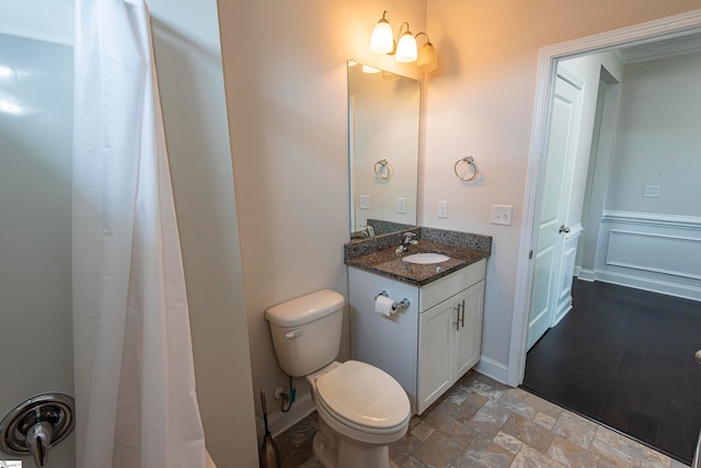 bathroom featuring toilet and vanity