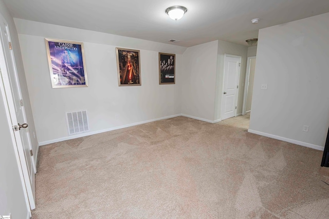 empty room featuring light colored carpet