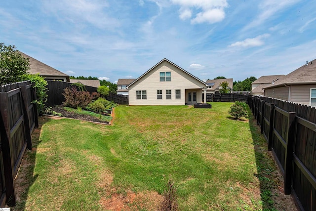 rear view of house featuring a yard