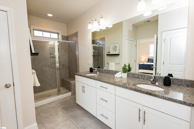 bathroom with walk in shower, vanity, and tile patterned floors