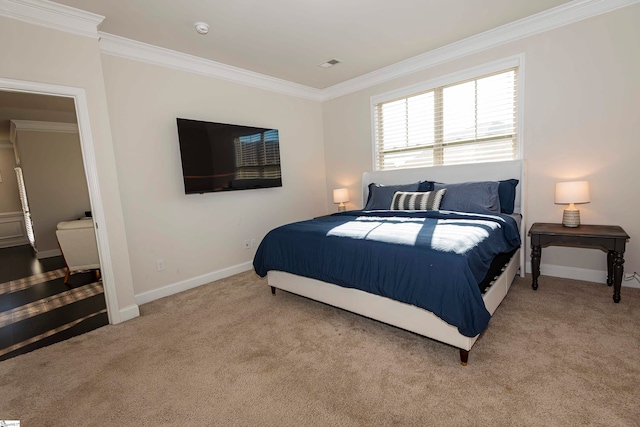 bedroom with ornamental molding and light colored carpet