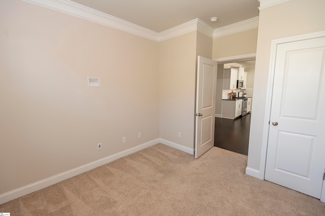 unfurnished bedroom featuring light colored carpet and crown molding