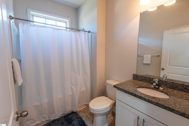 full bathroom featuring shower / tub combo with curtain, vanity, and toilet