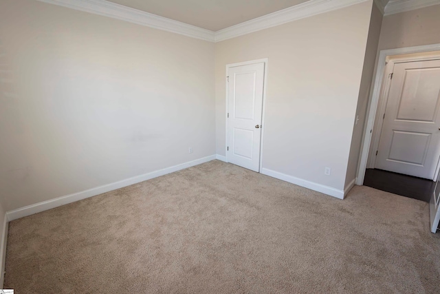 unfurnished room featuring ornamental molding and light colored carpet