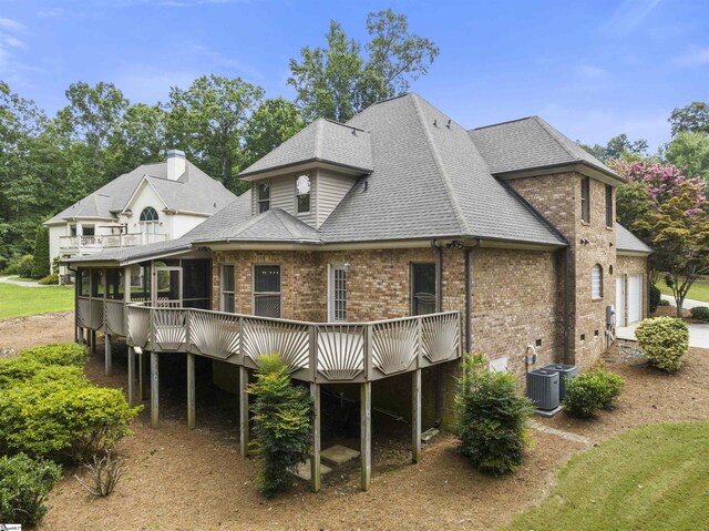 back of house with central AC and a wooden deck