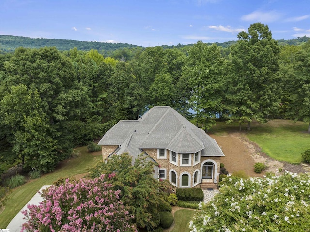 drone / aerial view featuring a view of trees