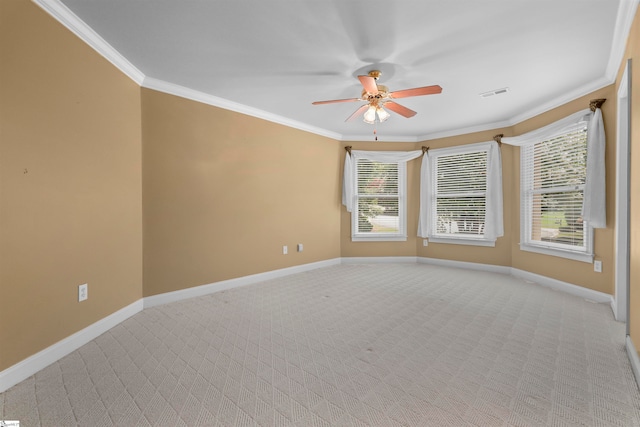 spare room with light colored carpet, ceiling fan, and ornamental molding