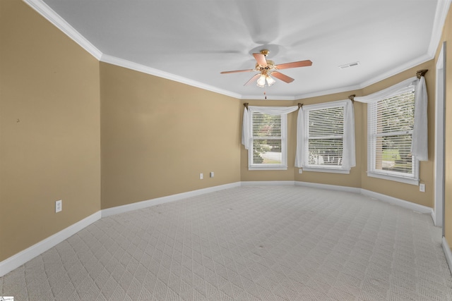 unfurnished room with baseboards, visible vents, ornamental molding, and light colored carpet