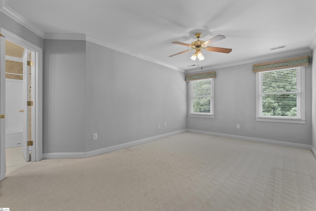 empty room featuring baseboards, carpet, visible vents, and crown molding