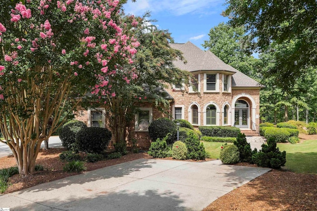 view of front of house with a front lawn and french doors