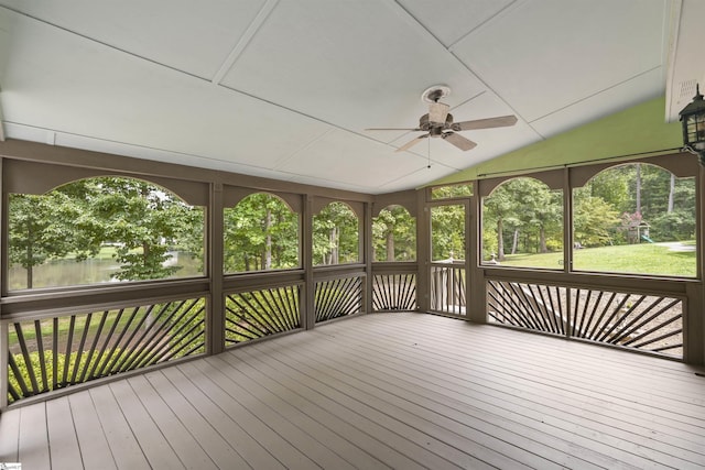 unfurnished sunroom featuring a ceiling fan and vaulted ceiling