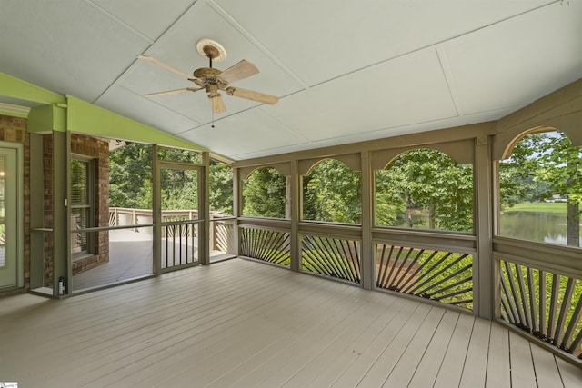 unfurnished sunroom with a water view, ceiling fan, and vaulted ceiling