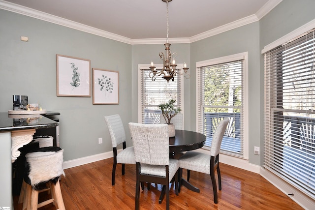 dining room featuring hardwood / wood-style floors, an inviting chandelier, and ornamental molding