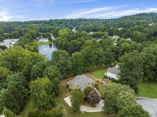 bird's eye view featuring a forest view and a water view