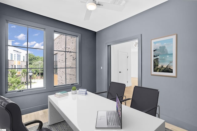 office space featuring ceiling fan and light hardwood / wood-style floors