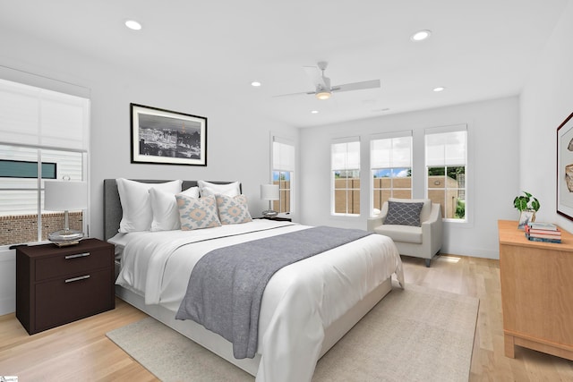 bedroom with ceiling fan and light wood-type flooring