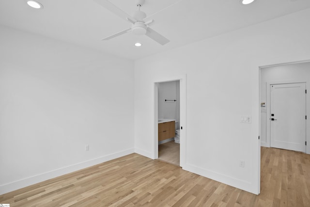 unfurnished bedroom with ceiling fan, connected bathroom, and light wood-type flooring