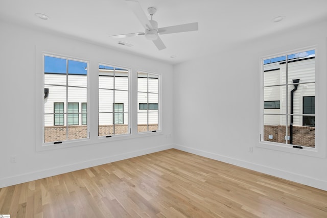 empty room featuring ceiling fan and light hardwood / wood-style floors