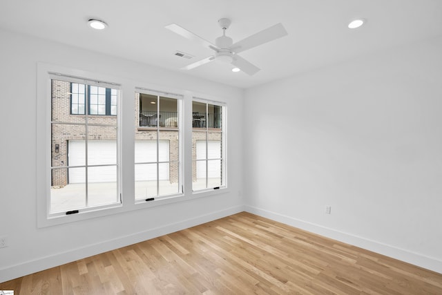 spare room with ceiling fan and light hardwood / wood-style floors