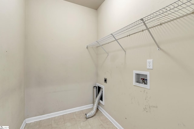 laundry area with hookup for an electric dryer, hookup for a washing machine, and light tile patterned floors