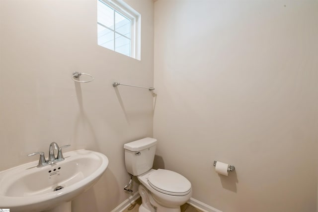 bathroom featuring sink and toilet