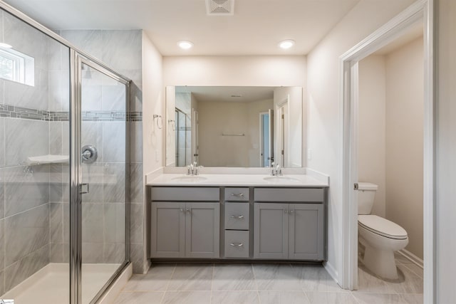 bathroom featuring walk in shower, dual bowl vanity, and tile patterned floors