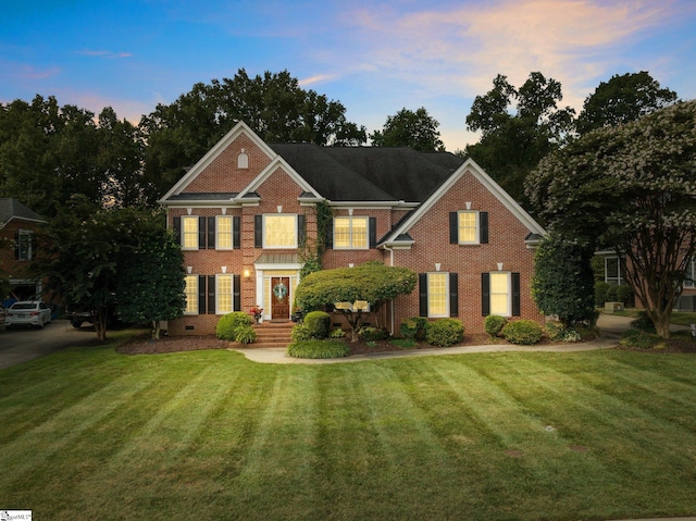 colonial home featuring a yard