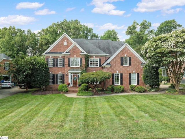 colonial-style house with a front yard