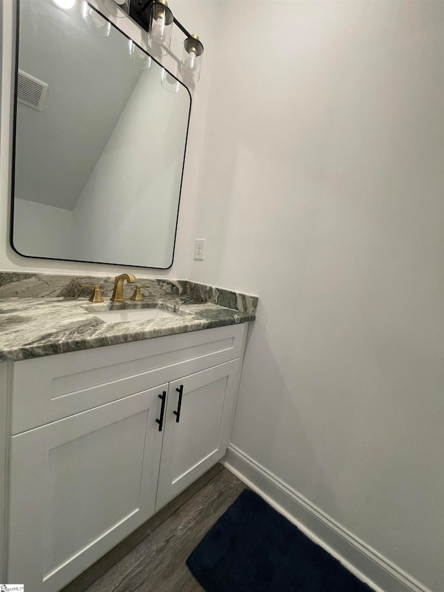 bathroom with vanity and hardwood / wood-style floors