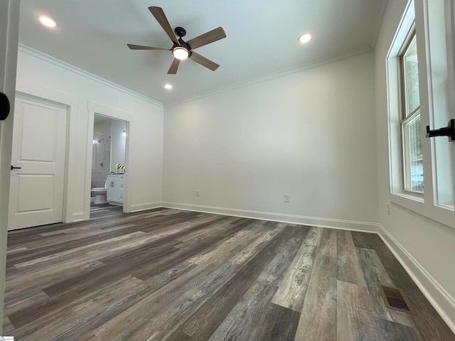 spare room with ceiling fan, crown molding, and dark wood-type flooring