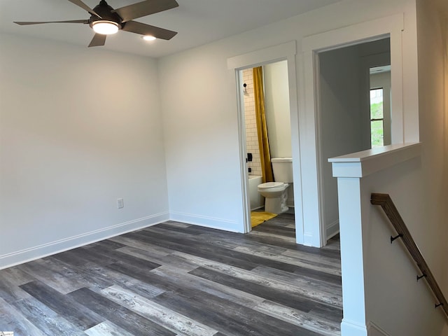 empty room featuring ceiling fan and dark wood-type flooring