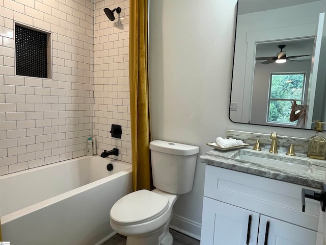 full bathroom featuring ceiling fan, tiled shower / bath, toilet, and vanity