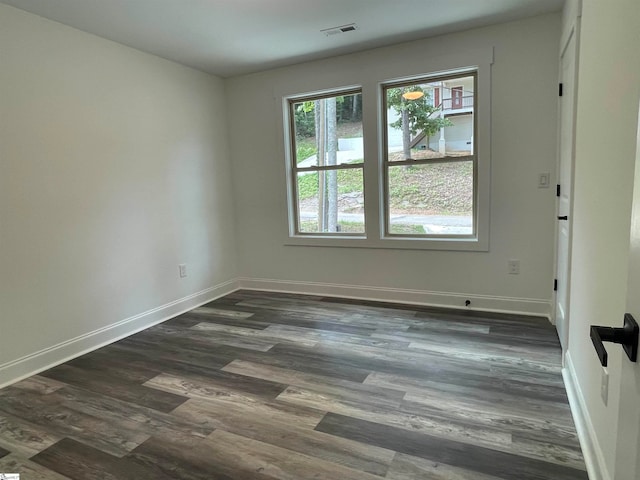 spare room with dark hardwood / wood-style floors