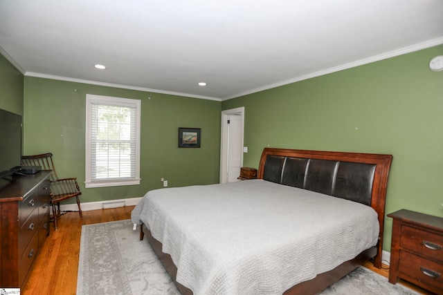 bedroom featuring light hardwood / wood-style flooring and ornamental molding