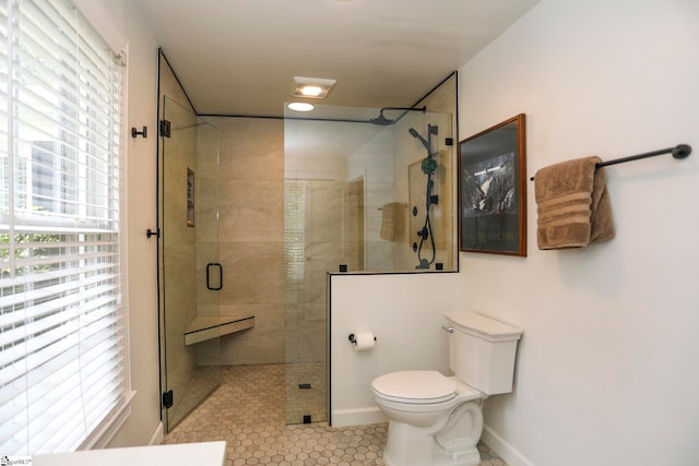 bathroom featuring tile patterned flooring, an enclosed shower, and toilet